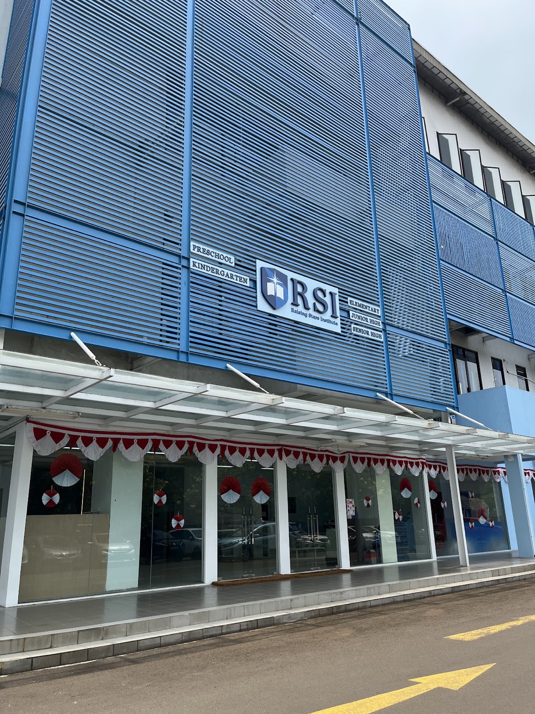 The Raising Stars Institute building on Jalan Pulo Mas Utara, with the school crest and level signage on the facade